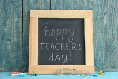 Photo of Composition with small chalkboard for Teacher's day on table