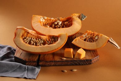 Photo of Cut fresh ripe pumpkin on orange background