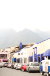 San Pedro Garza Garcia, Mexico – February 8, 2023: Blurred view of street with parked cars and beautiful buildings