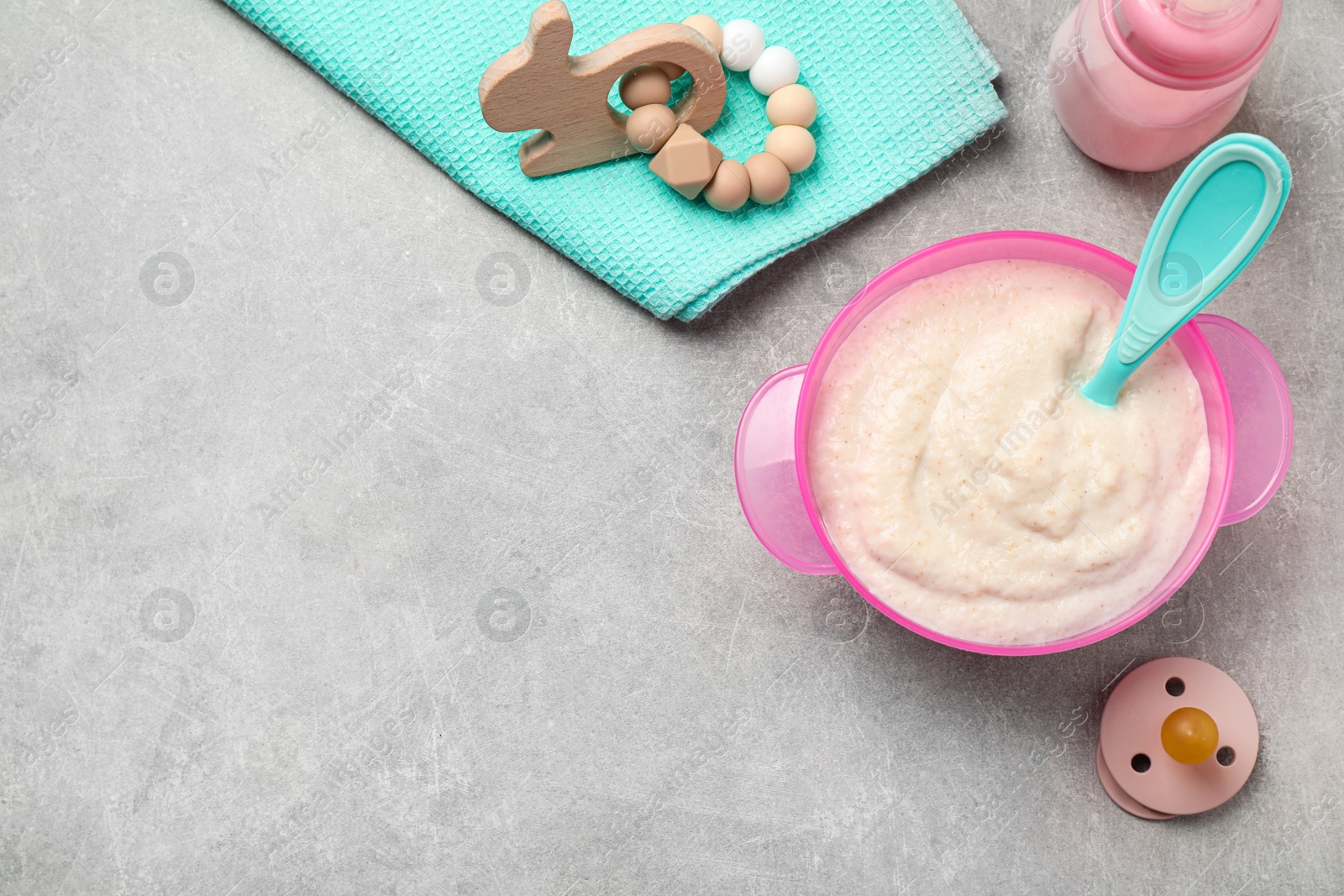 Photo of Flat lay composition with healthy baby food on grey table, space for text