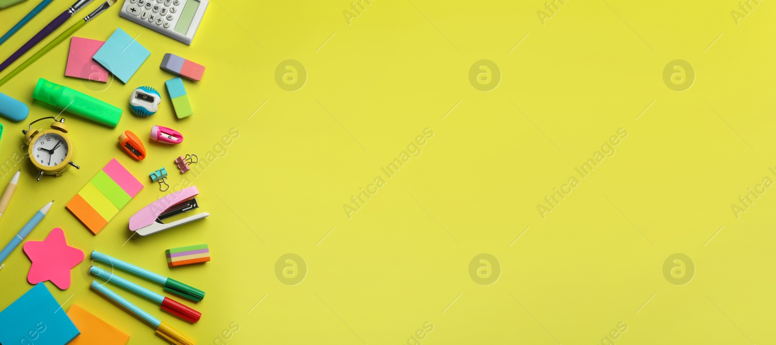 Photo of School stationery on yellow background, flat lay with space for text. Back to school