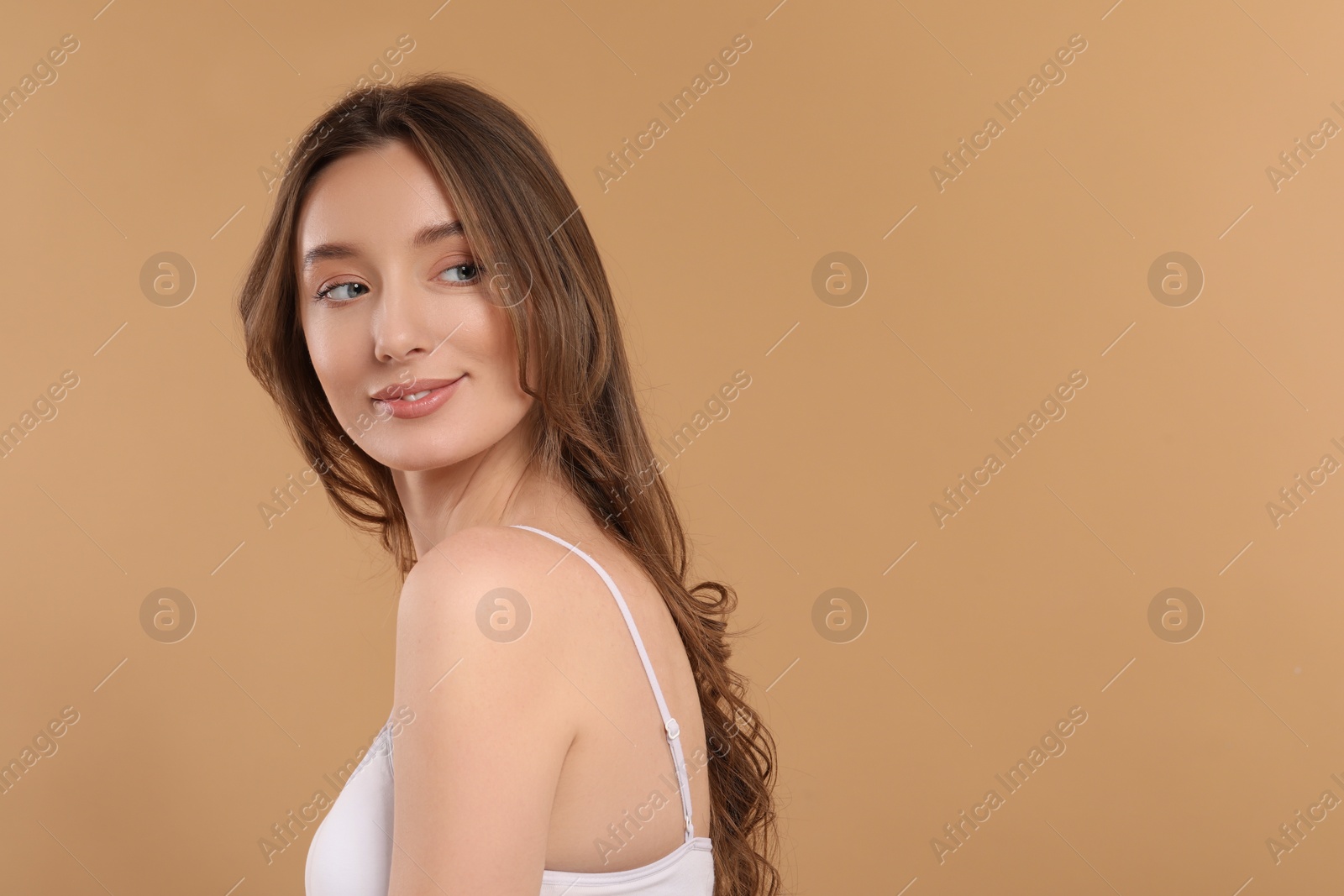 Photo of Beautiful woman with healthy skin on beige background, space for text