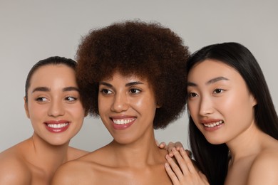 Portrait of beautiful young women on light grey background