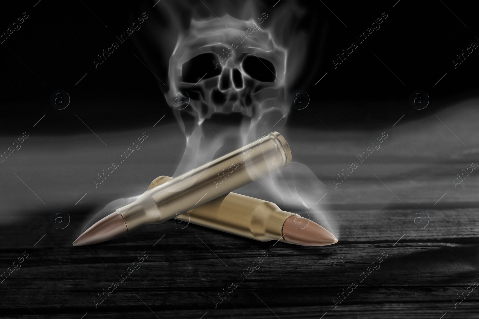 Image of Bullets with skull shaped smoke on black wooden table