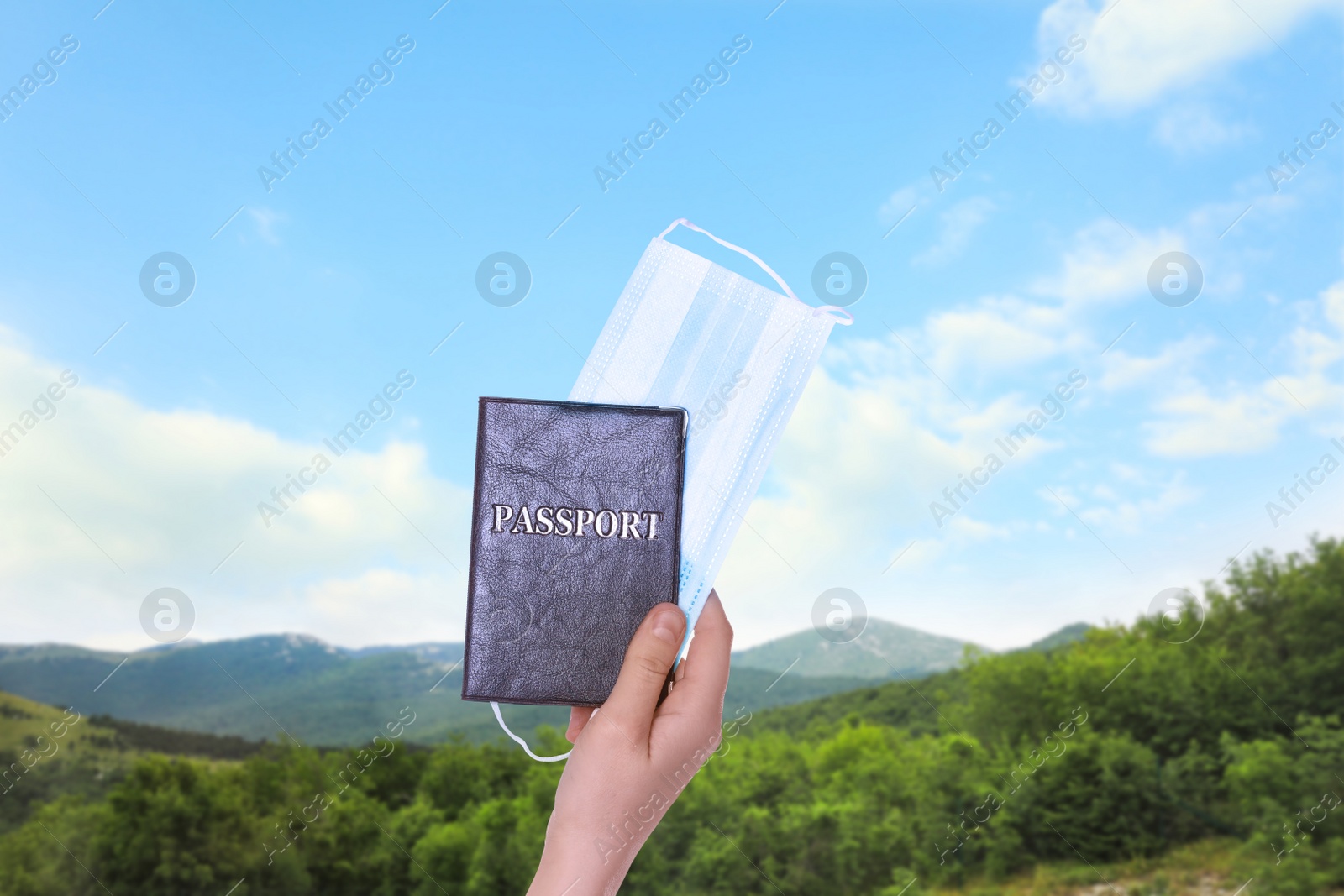 Image of Woman holding passport and protective mask outdoors, closeup. Travel during quarantine