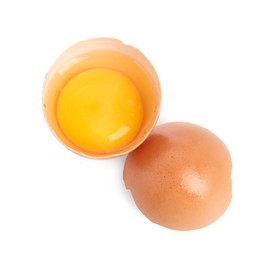 Photo of Cracked chicken egg with yolk isolated on white, top view