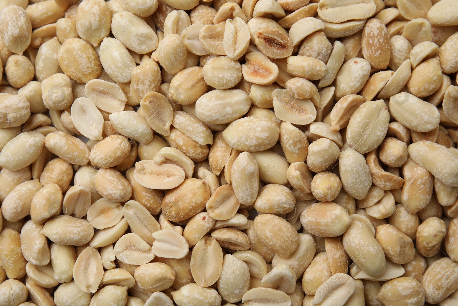 Photo of Many fresh peeled peanuts as background, top view