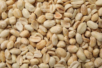 Photo of Many fresh peeled peanuts as background, top view