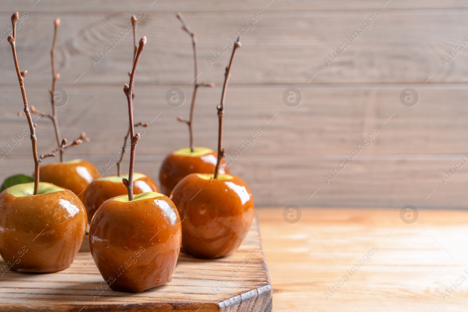 Photo of Delicious green caramel apples on table