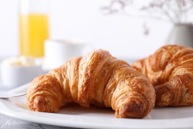 Photo of Tasty breakfast. Fresh croissants on table, closeup