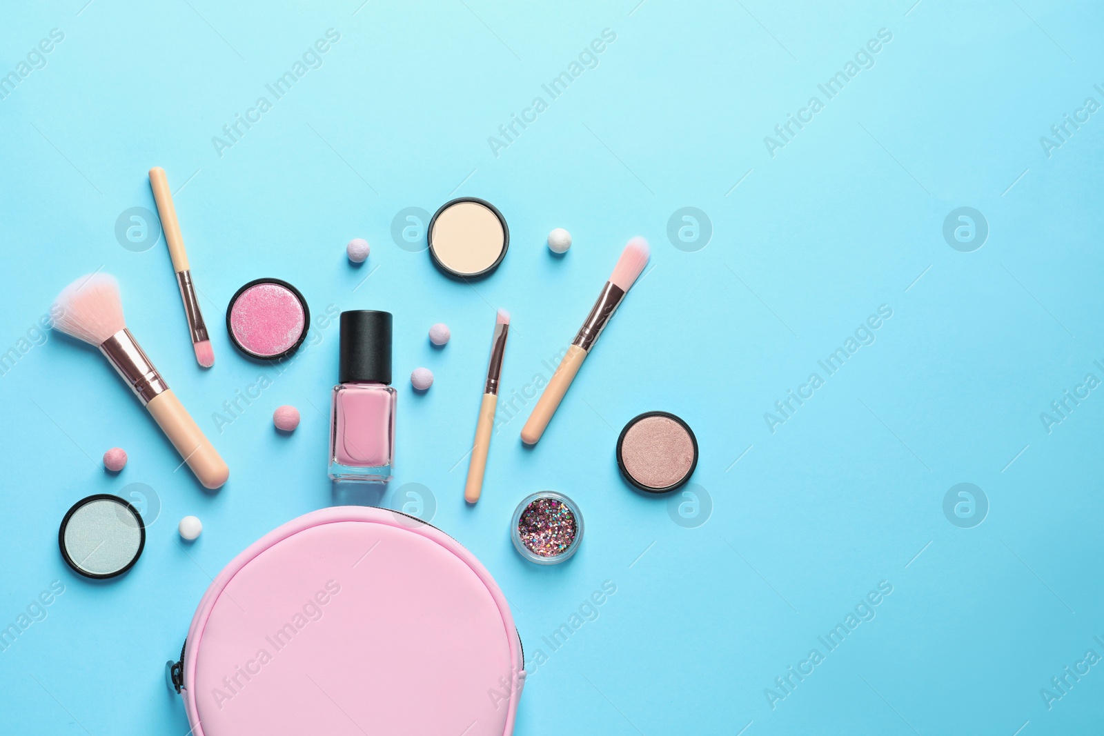 Photo of Makeup products with cosmetic bag on color background