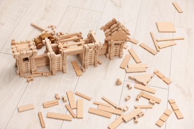 Wooden construction set on floor indoors. Children's toy