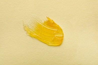 Smear of ointment on beige background, top view