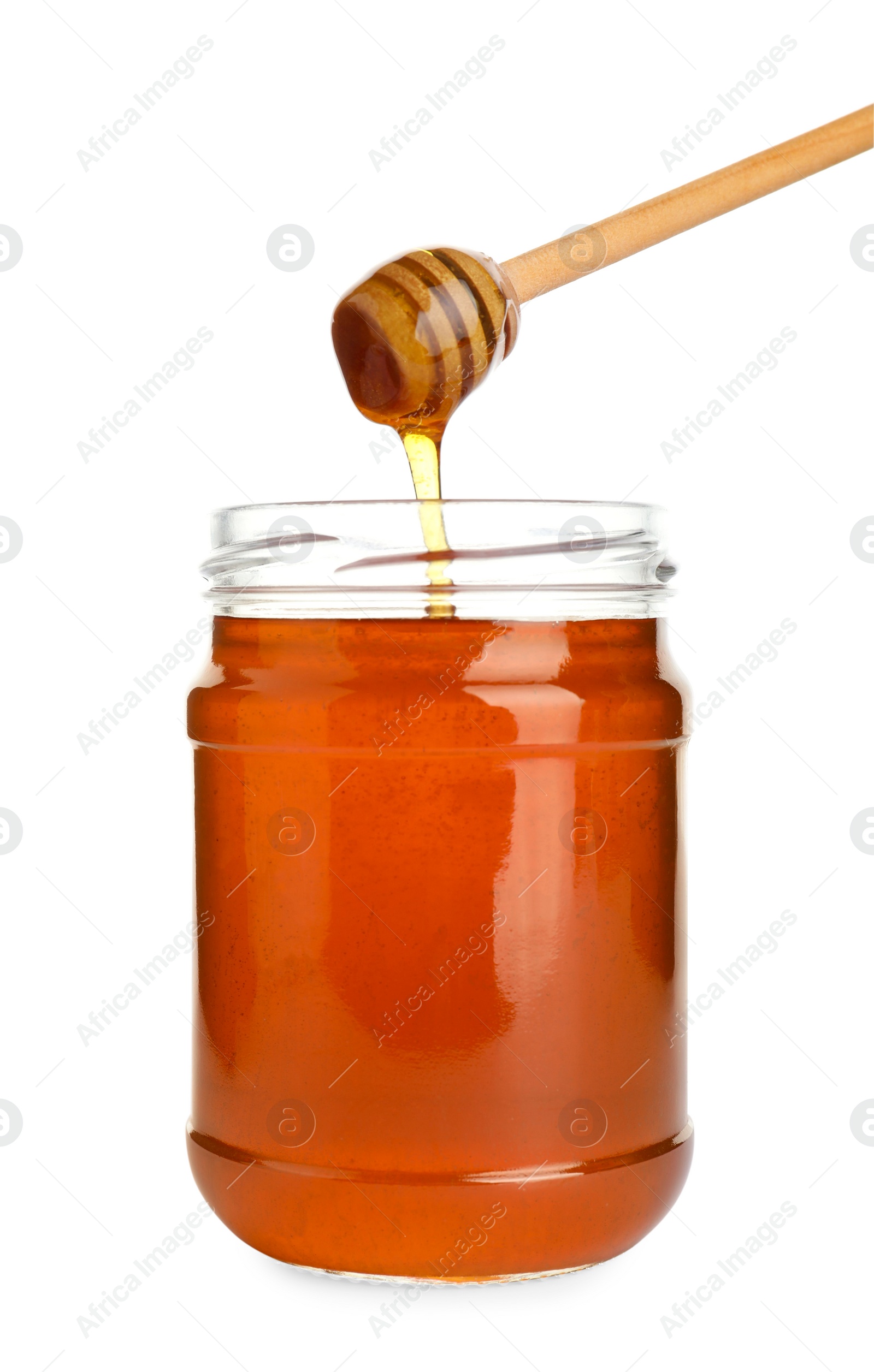 Photo of Glass jar of wildflower honey and wooden dipper isolated on white