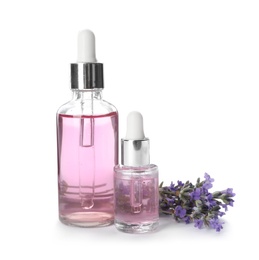 Photo of Bottles with natural lavender oil and flowers on white background