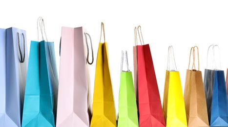 Photo of Colorful paper shopping bags on white background