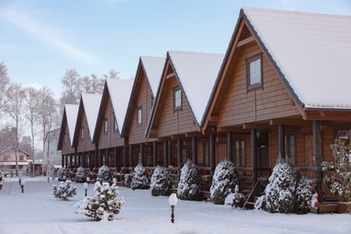 Photo of Winter landscape with beautiful houses, trees and bushes in morning