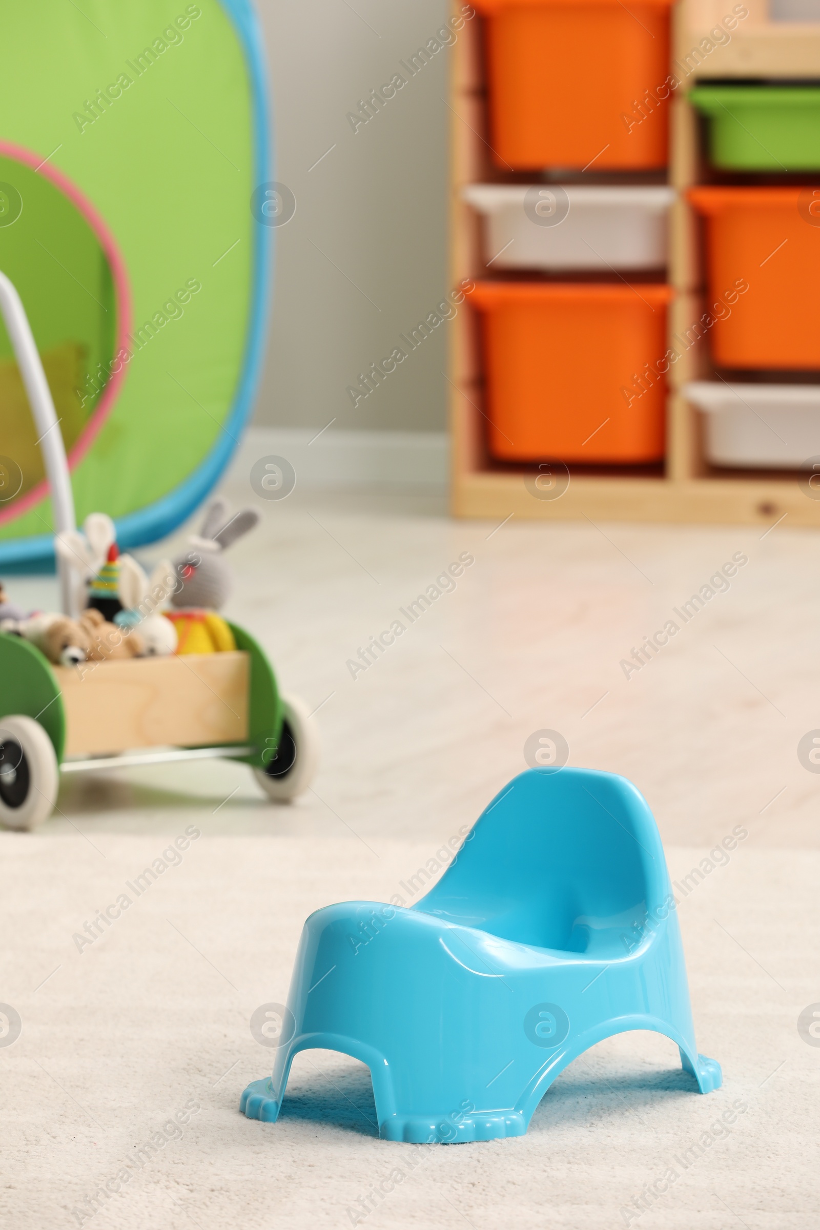 Photo of Light blue baby potty in room. Toilet training