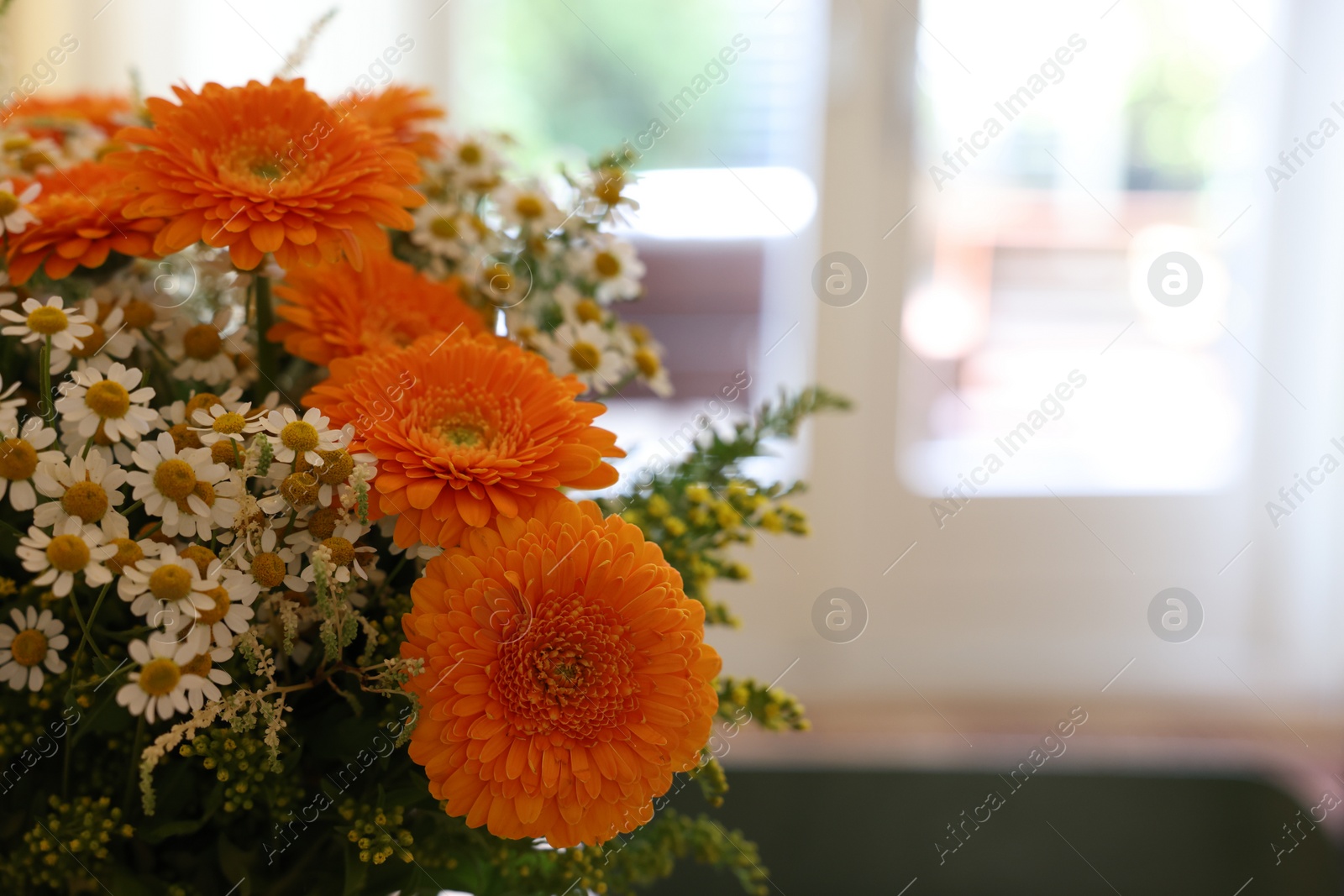 Photo of Fresh bouquet of chamomile and calendula flowers, closeup. Space for text