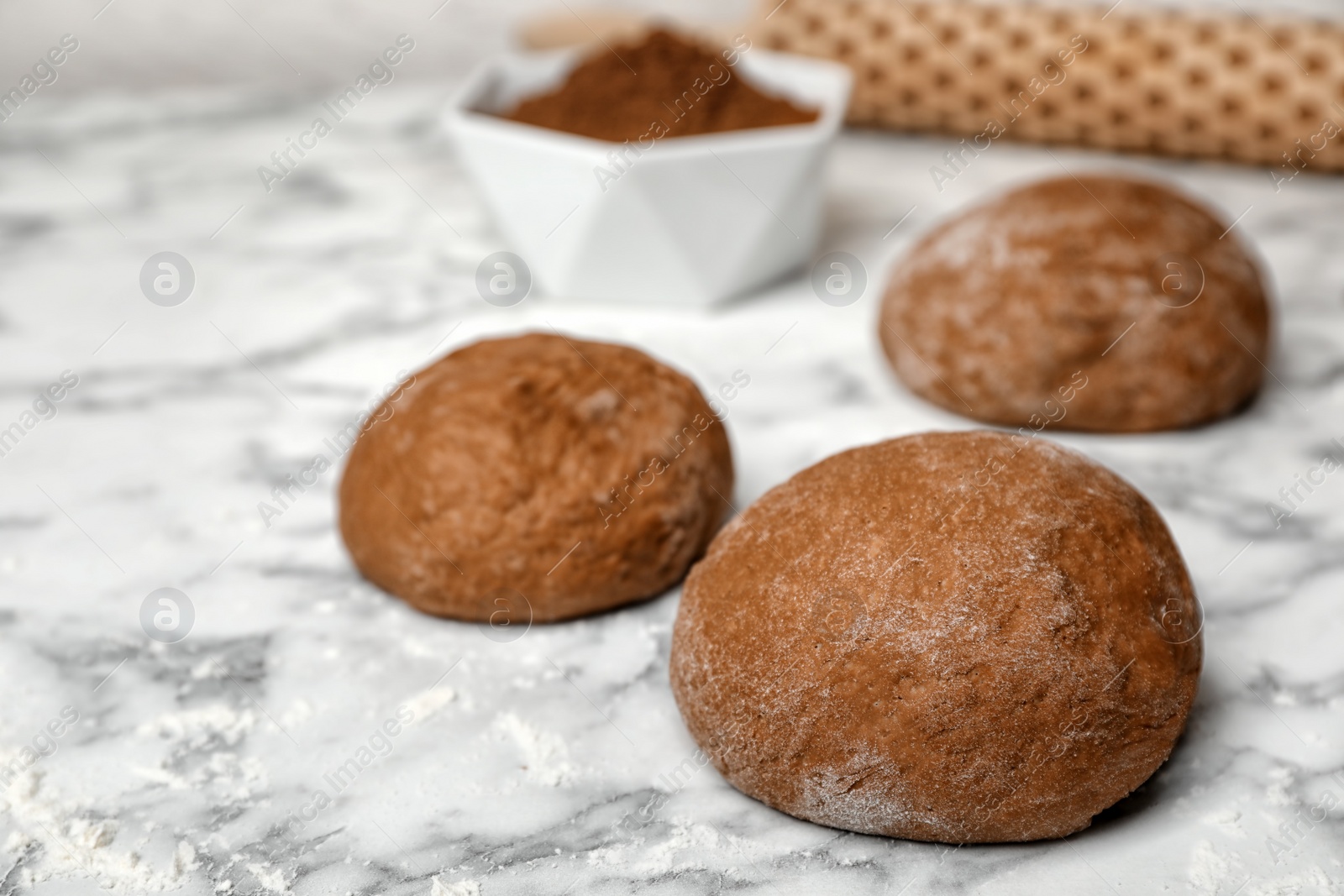 Photo of Raw rye dough on marble table, closeup