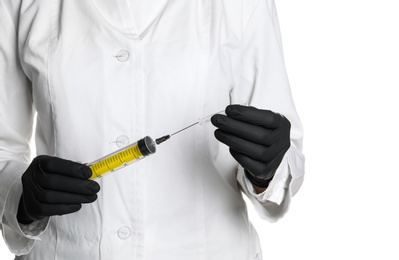 Doctor in medical gloves holding empty syringe on white background