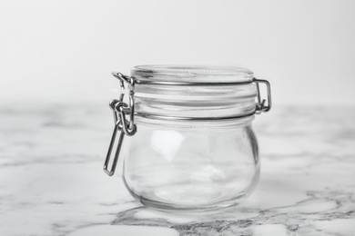 Empty glass jar on white marble table