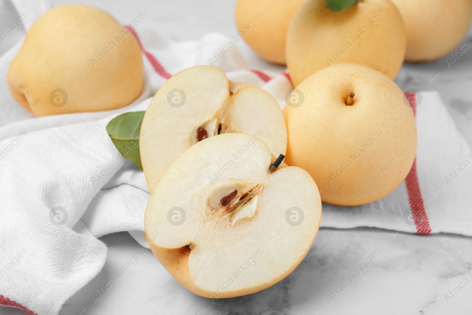 Photo of Delicious apple pears on white marble table