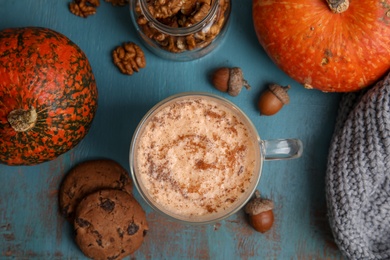 Photo of Flat lay composition with pumpkin spice latte on wooden background