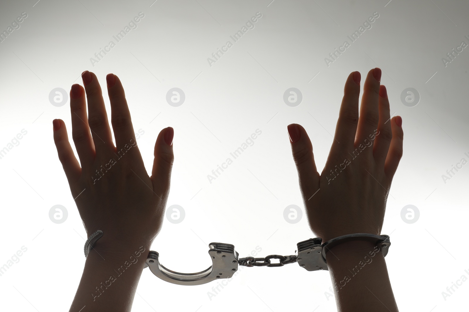 Photo of Freedom concept. Woman with handcuffs on white background, closeup