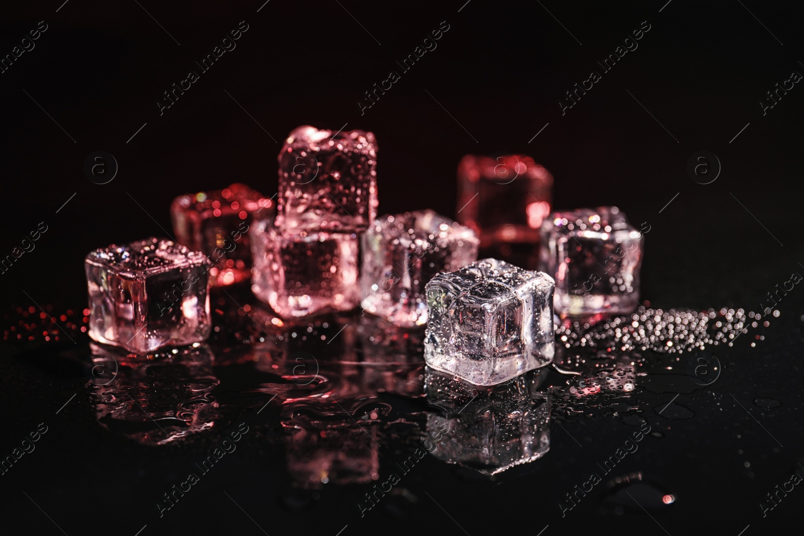 Photo of Pile of crystal clear ice cubes on black background