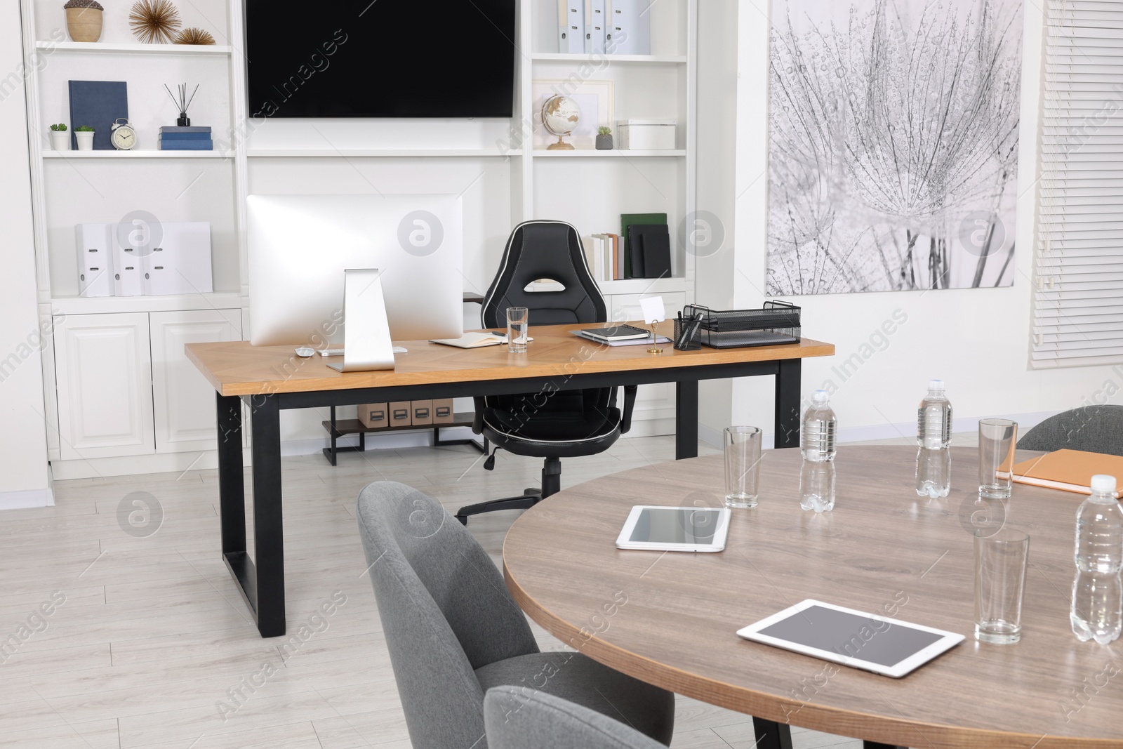 Photo of Stylish office with comfortable furniture and tv zone. Interior design