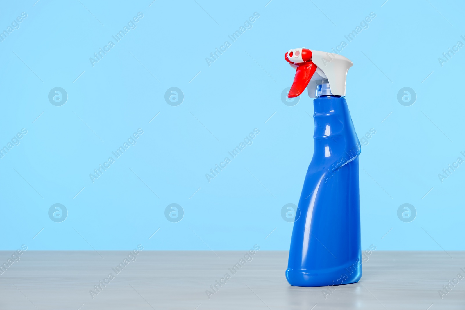 Photo of Bottle of cleaning product on light table. Space for text