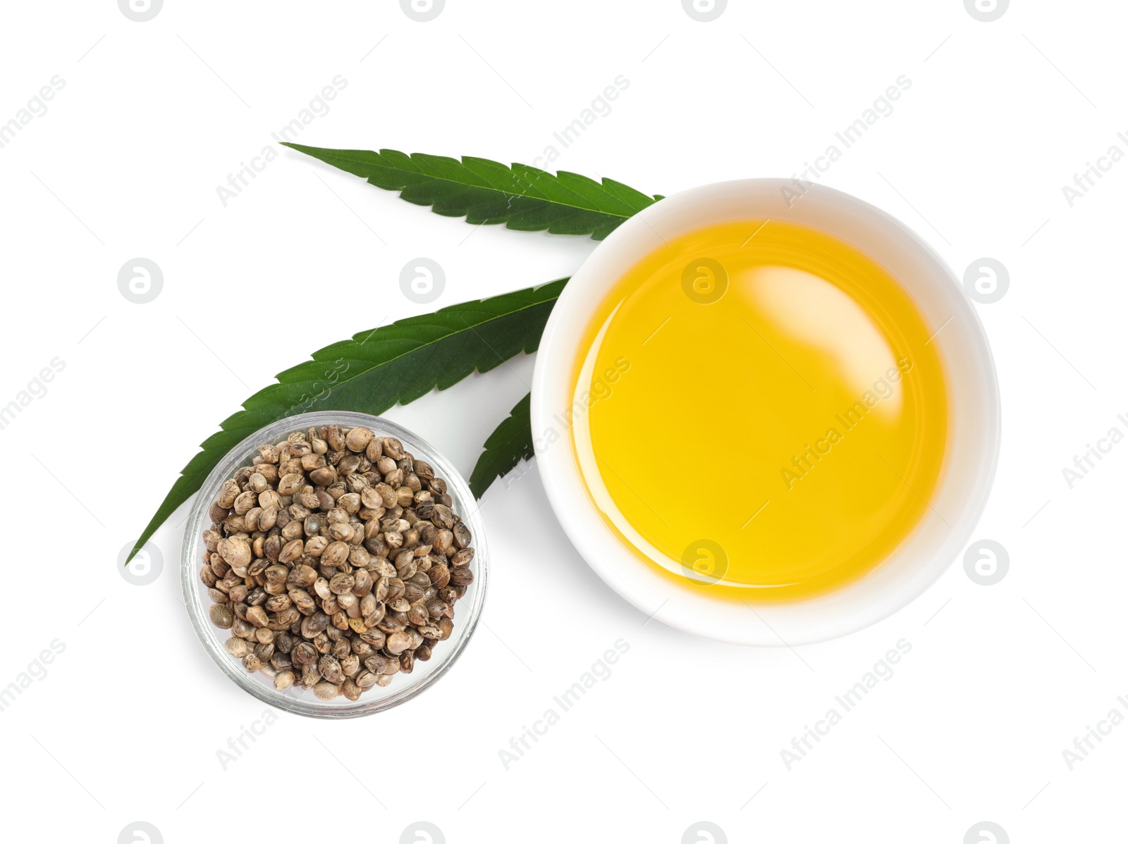 Photo of Hemp oil, fresh leaf and seeds on white background, top view