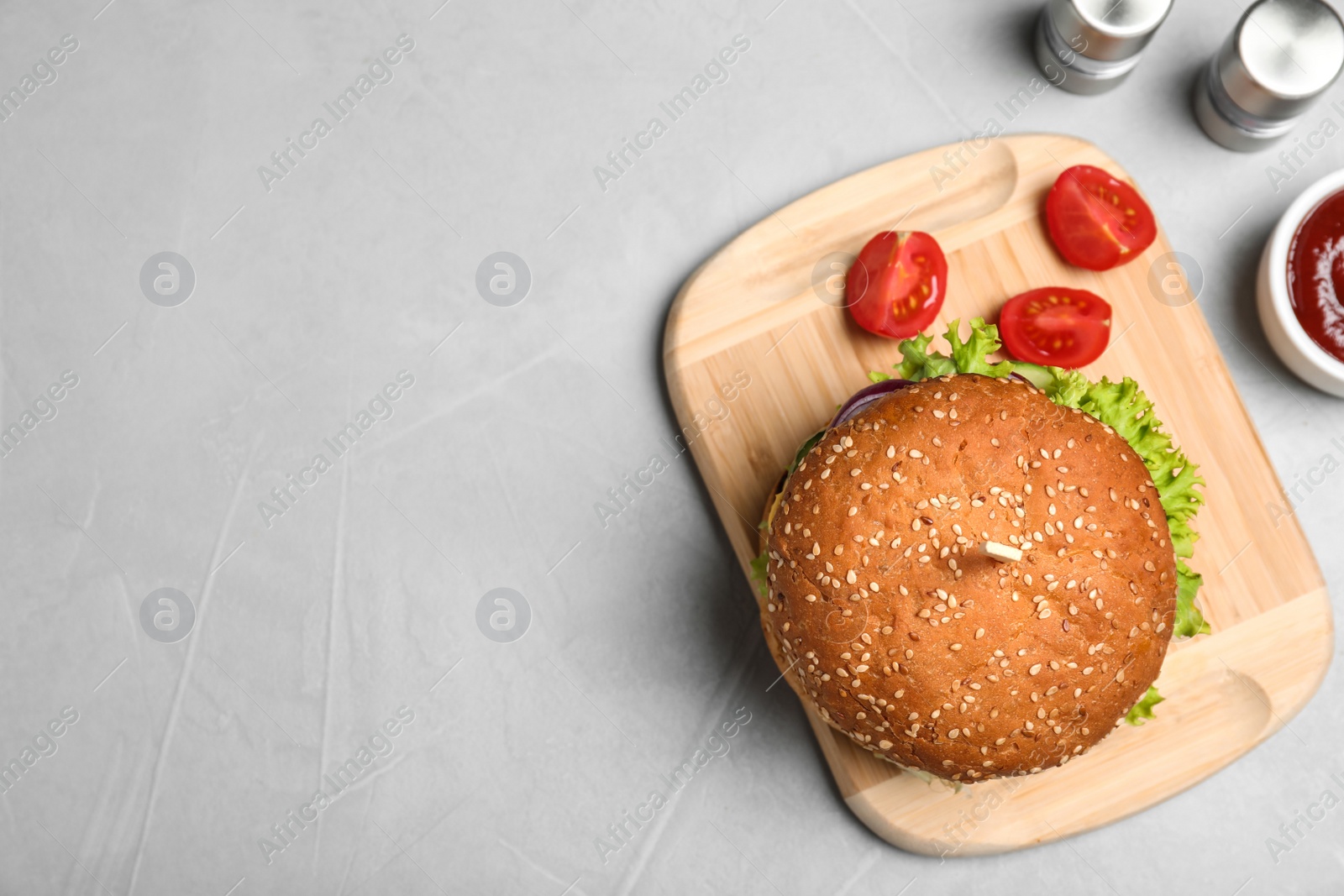 Photo of Flat lay composition with tasty burger on table. Space for text