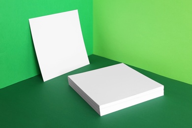 Photo of Empty sheets on color background. Mockup for design