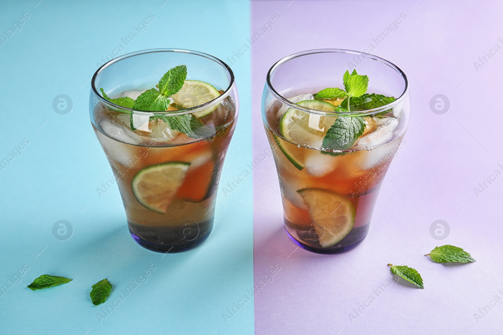 Photo of Glasses of refreshing iced tea on color background