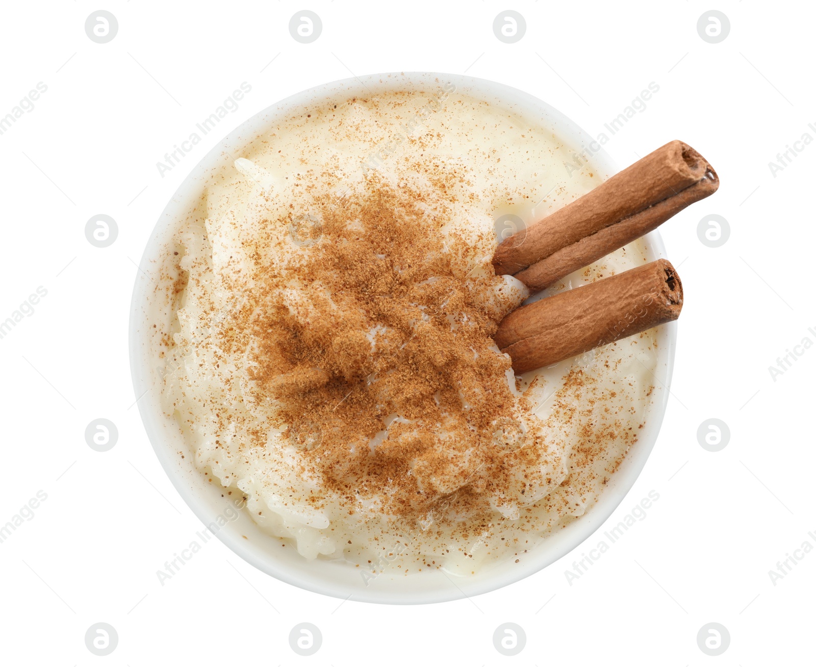 Photo of Delicious rice pudding with cinnamon isolated on white, top view