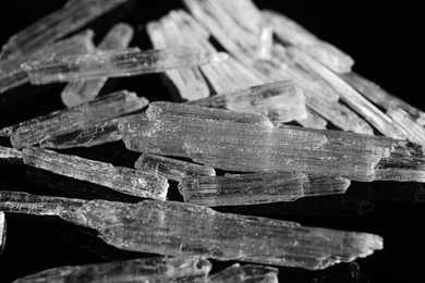 Photo of Menthol crystals on black background, closeup view