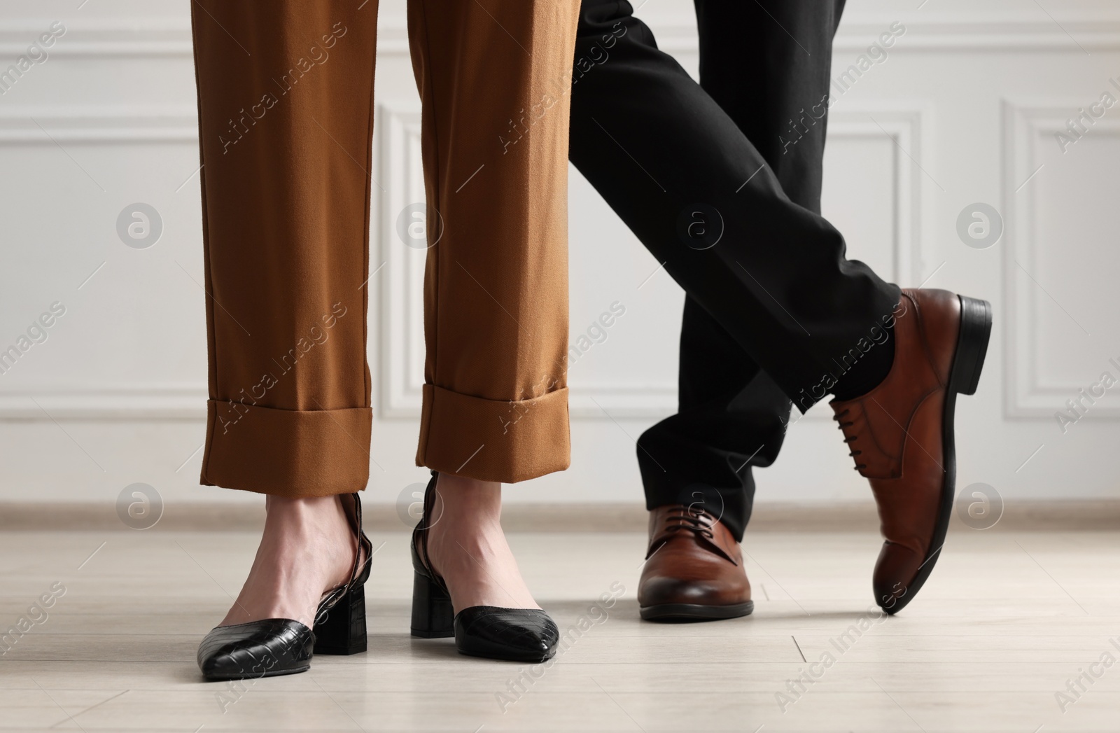 Photo of Businessman and businesswoman in elegant shoes indoors, closeup