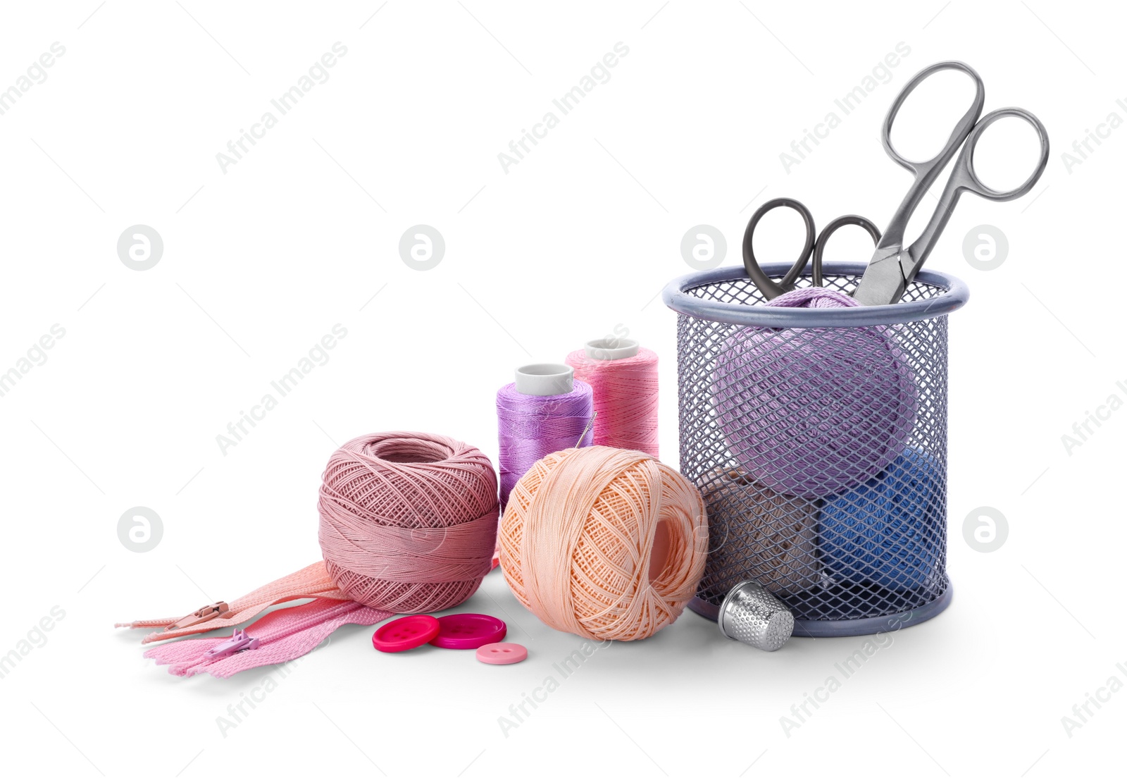 Photo of Color threads and sewing accessories on white background