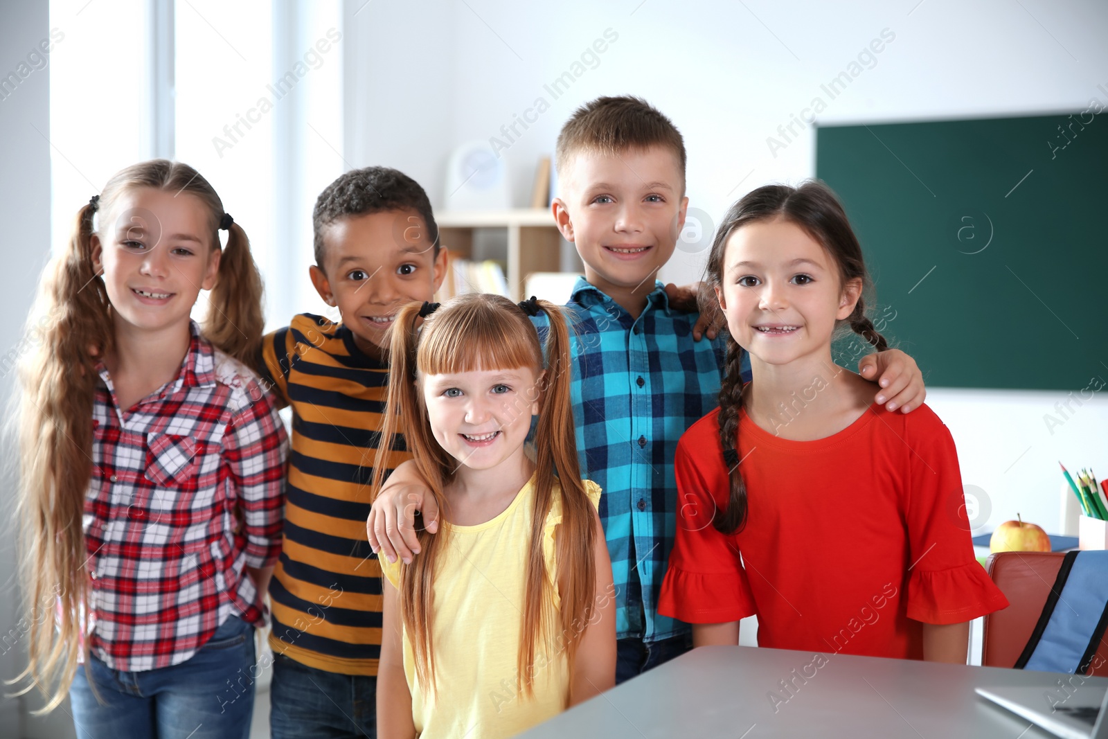 Photo of Cute little children in classroom. Elementary school