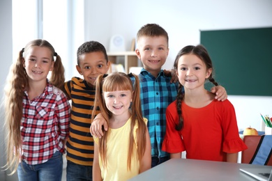 Photo of Cute little children in classroom. Elementary school