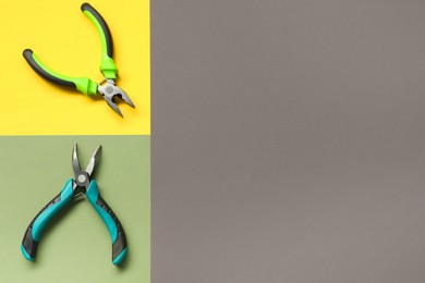 Photo of Pliers on color background, flat lay. Space for text