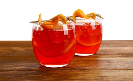Photo of Aperol spritz cocktail and orange slices in glasses on wooden table against white background