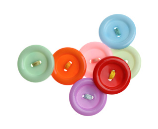 Many colorful sewing buttons on white background, top view