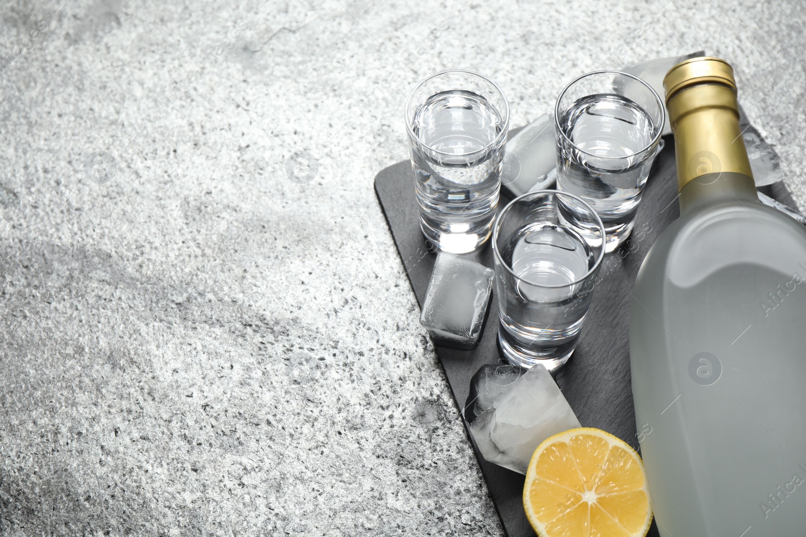 Photo of Cold Russian vodka on grey table, above view. Space for text