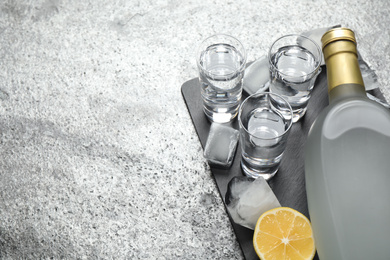 Photo of Cold Russian vodka on grey table, above view. Space for text
