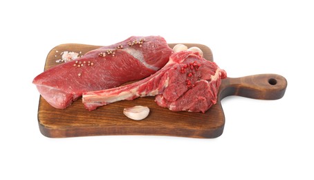 Photo of Board with pieces of raw beef meat and spices isolated on white