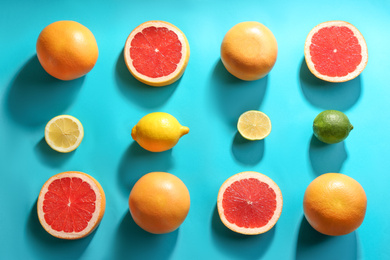 Photo of Flat lay composition with ripe grapefruits on blue background