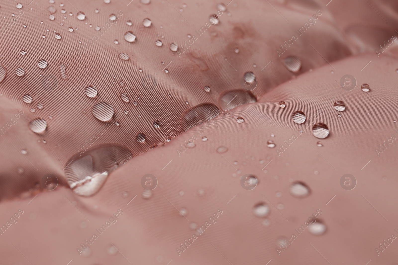 Photo of Pink waterproof fabric with water drops as background, closeup